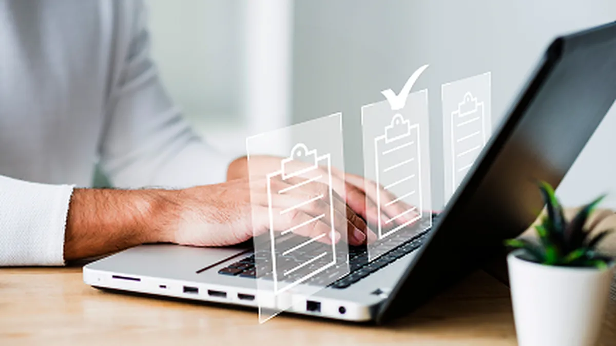 Property manager checking off a maintenance checklist on a laptop